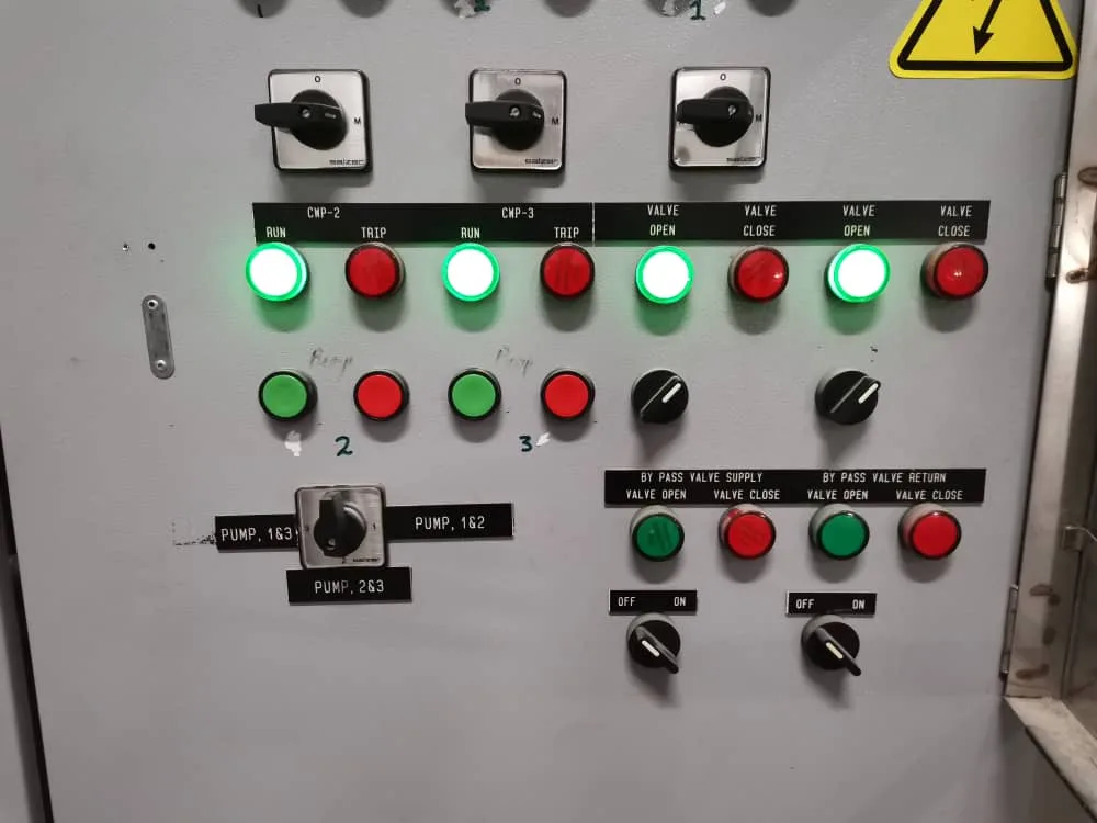 Technician performing BMS installation to control HVAC and lighting in a commercial building.